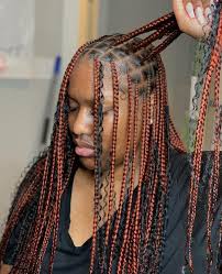 Woman with knotless braids using the perfect hair extensions