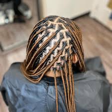 Woman with knotless braids styled for summer in Dallas