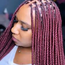Woman wearing knotless braids walking confidently in downtown Dallas